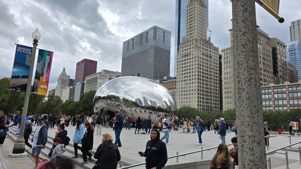 A picture of The Bean, with crowds in front.