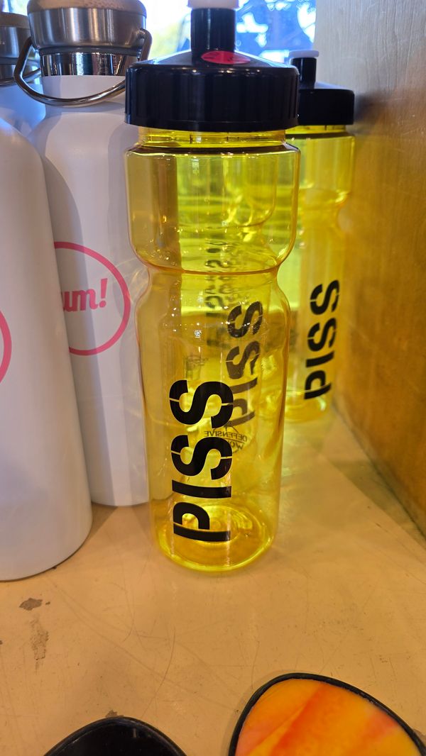 A yellow, translucent bottle labeled 'PISS'