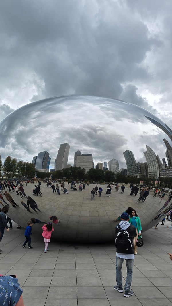 A closer-up view of The Bean, with several people in frame.