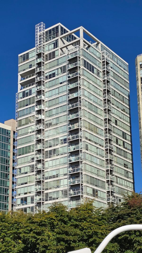 A large, glass apartment building shot from a boat on the Chicago River